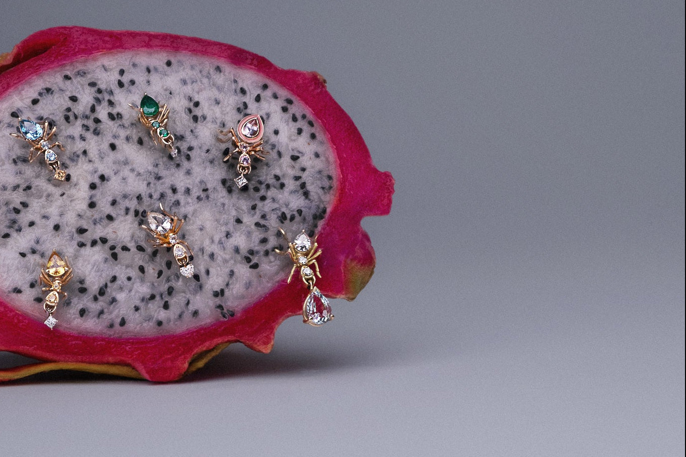 Cocoerow Kokoro Ant Stud Earrings in yellow gold styled on a sliced dragon fruit, lifestyle shot