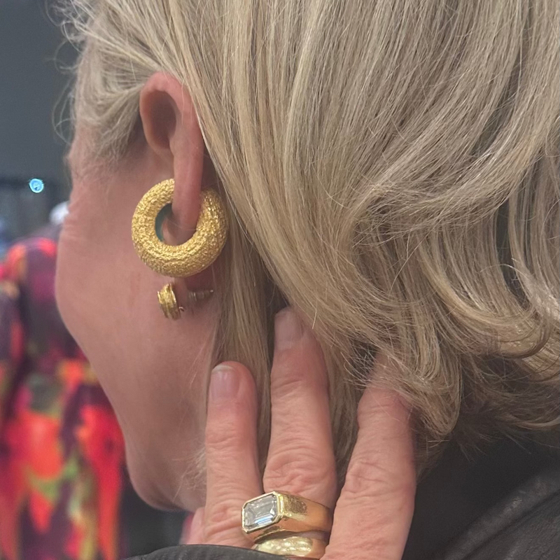 Client of Cocoerow Fine jewelry in textured gold ear cuff