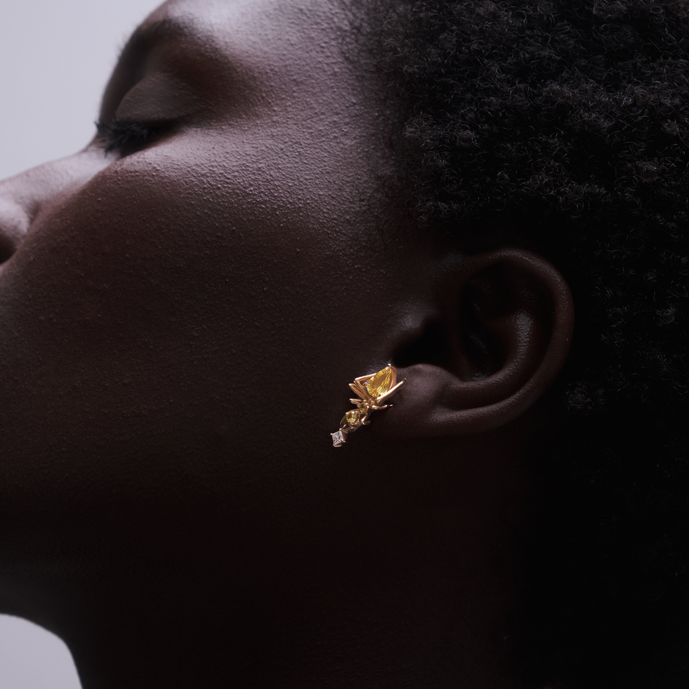 Model wearing Cocoerow Kokoro Ant Yellow Sapphire Stud Earring in yellow gold