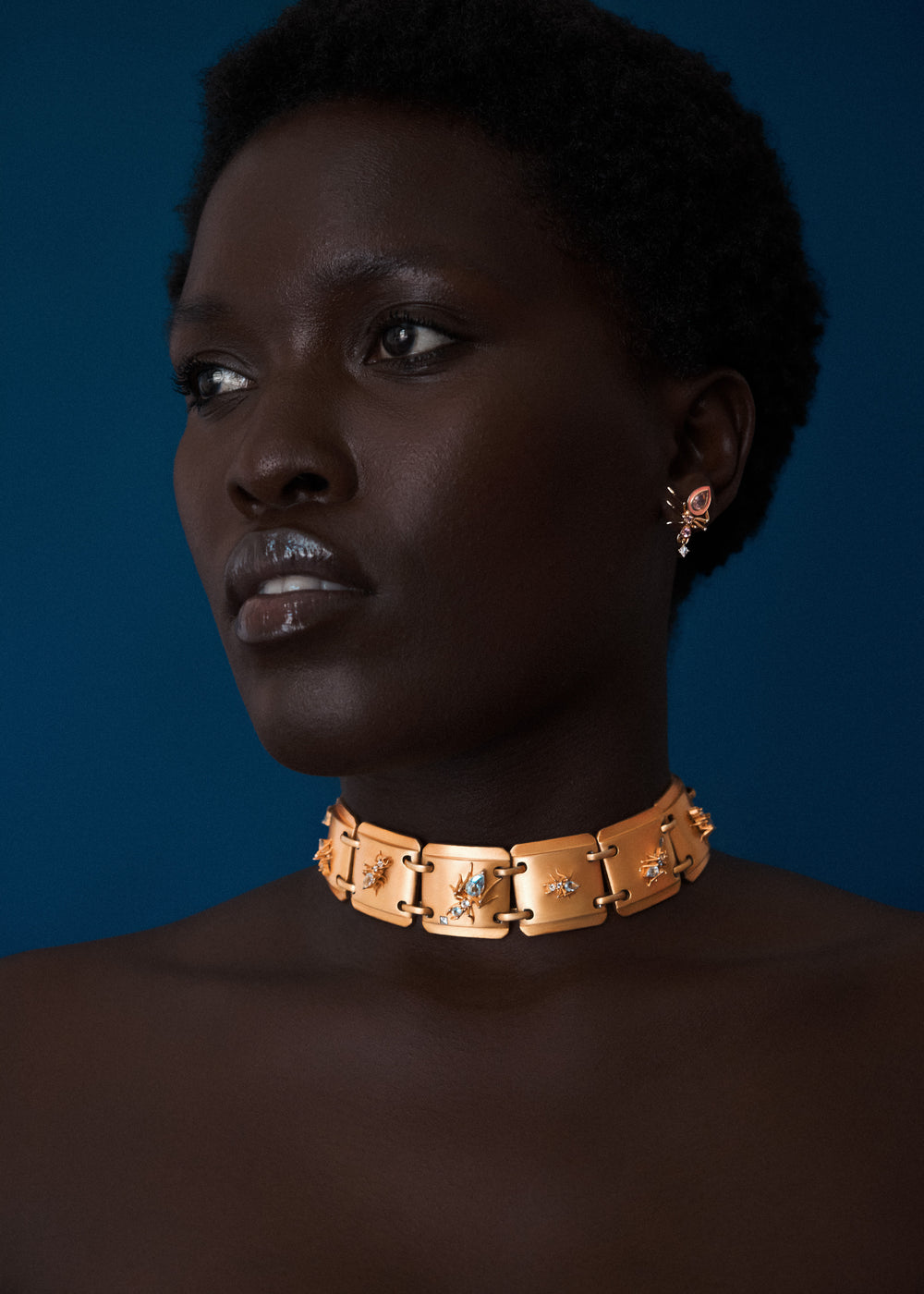 Model wearing Ojukokoro choker necklace, yellow gold vermeil with aquamarine gemstones, Cocoerow